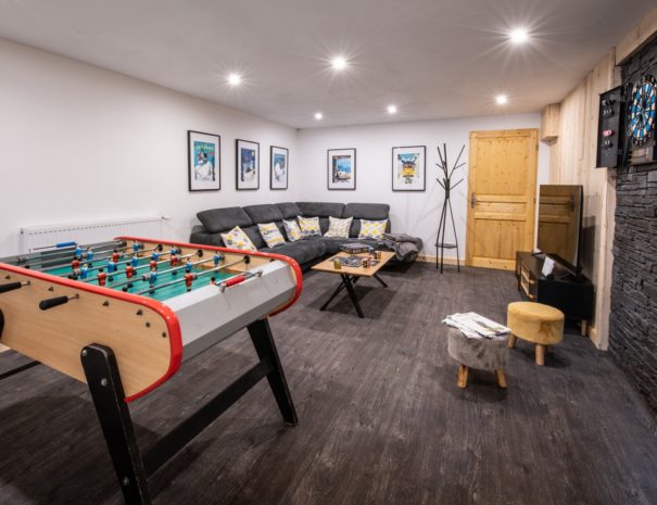 Game room with table soccer and sofas in chalet Snow Valley