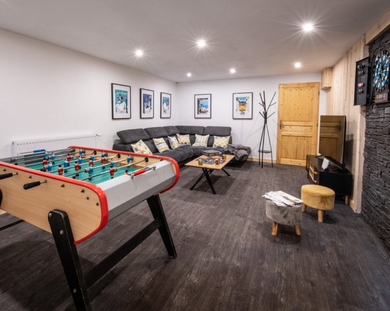 Game room with table soccer and sofas in chalet Snow Valley